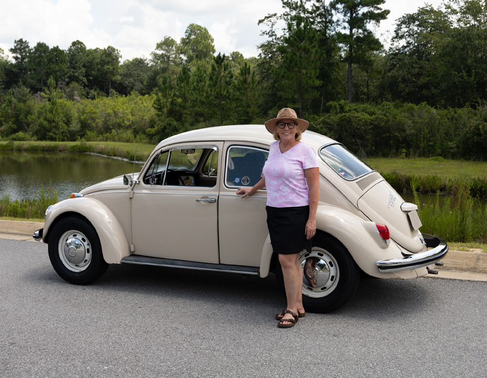 Classic 1968 Volkswagen Beetle parked at vintage VW car show with it's owner