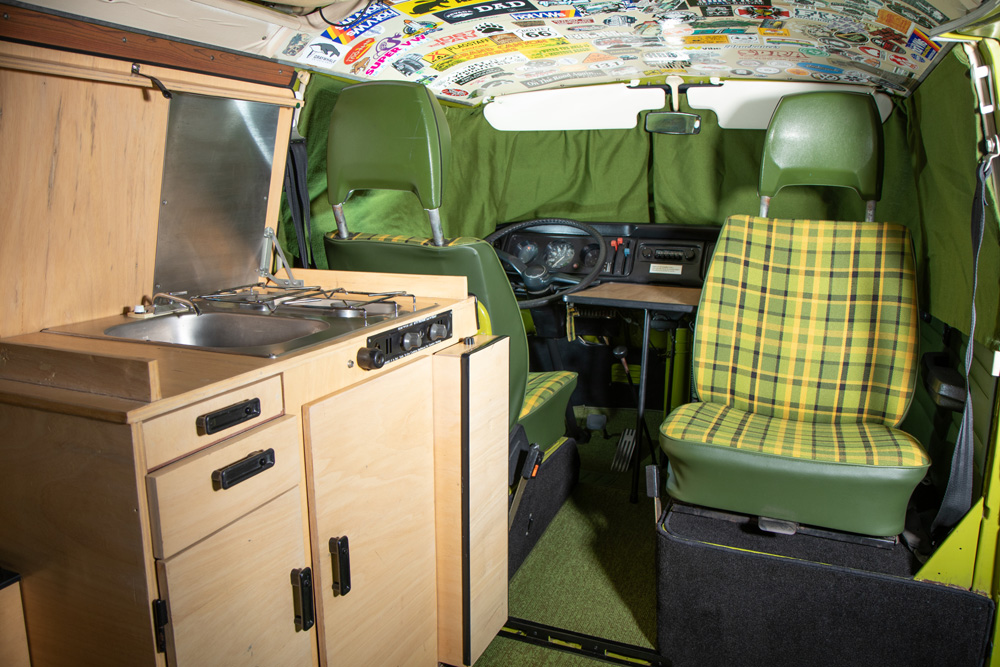 VW Westfalia cab headliner covered in vintage travel and event stickers