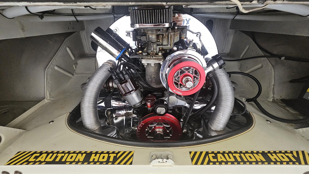 Custom air cooled VW engine with polished components and red MST parts in the bay
