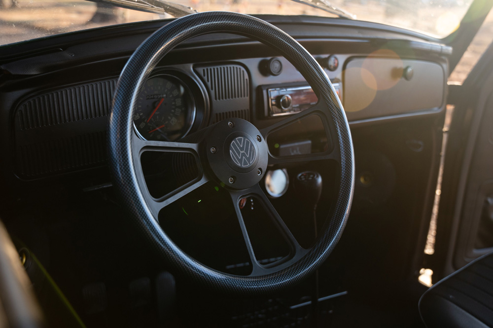 Vintage Volkswagen steering wheel and dashboard with speedometer and radio controls