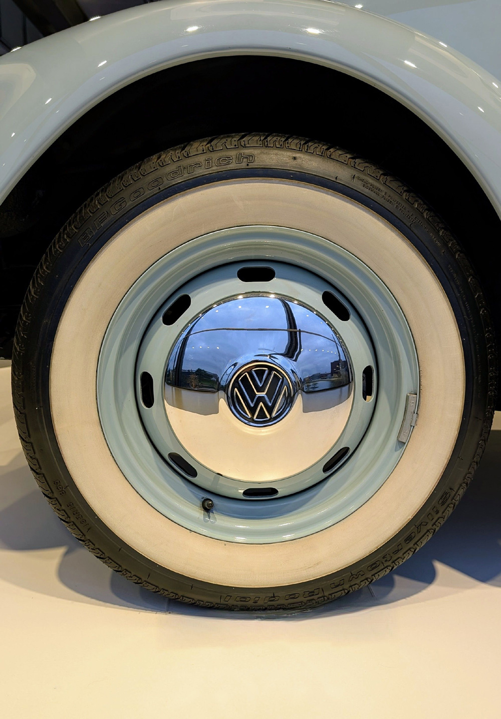Close-up of vintage Volkswagen wheel with chrome hubcap and whitewall BFGoodrich tire