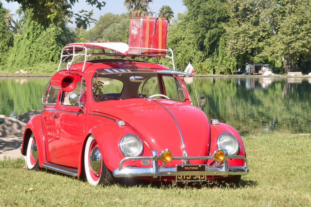 Red Volkswagen Beetle parked by the water at he El Prado VW Show & Shine.
