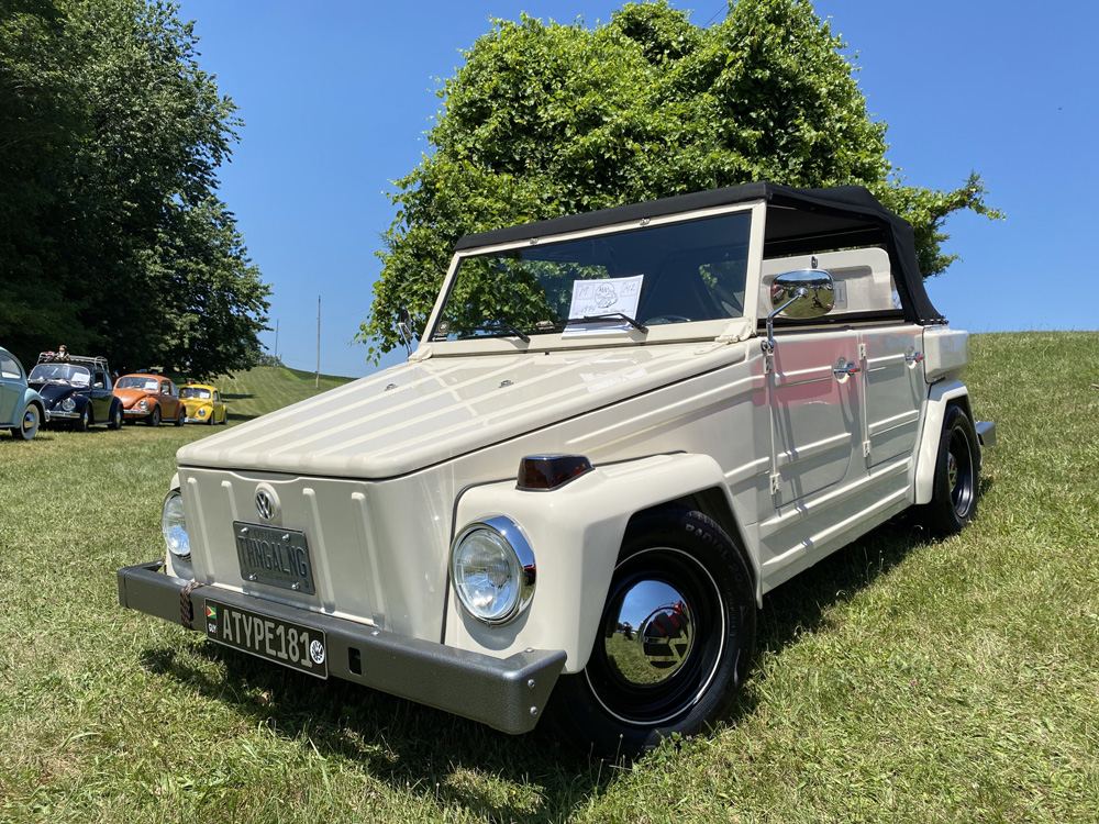 Cream Volkswagen Thing displayed at Bug Out 44 with other classic VWs in background