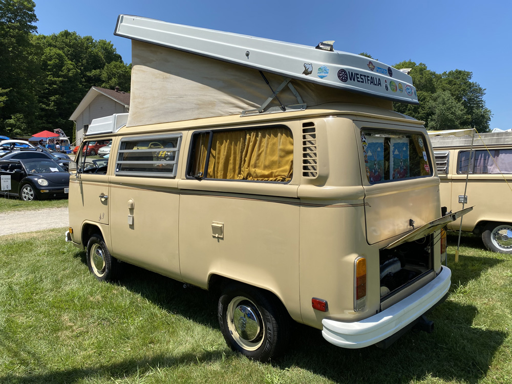 Beige Volkswagen Westfalia camper with pop-top raised at Bug Out 44